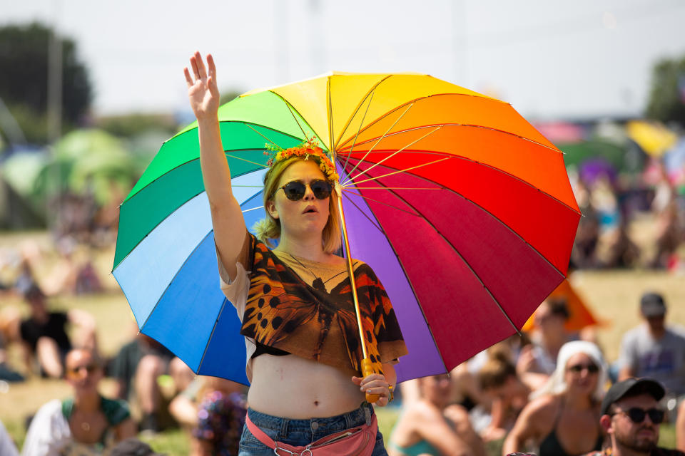 A festival goer in the sun at Glastonbury Festival at Worthy Farm in Pilton, Somerset.