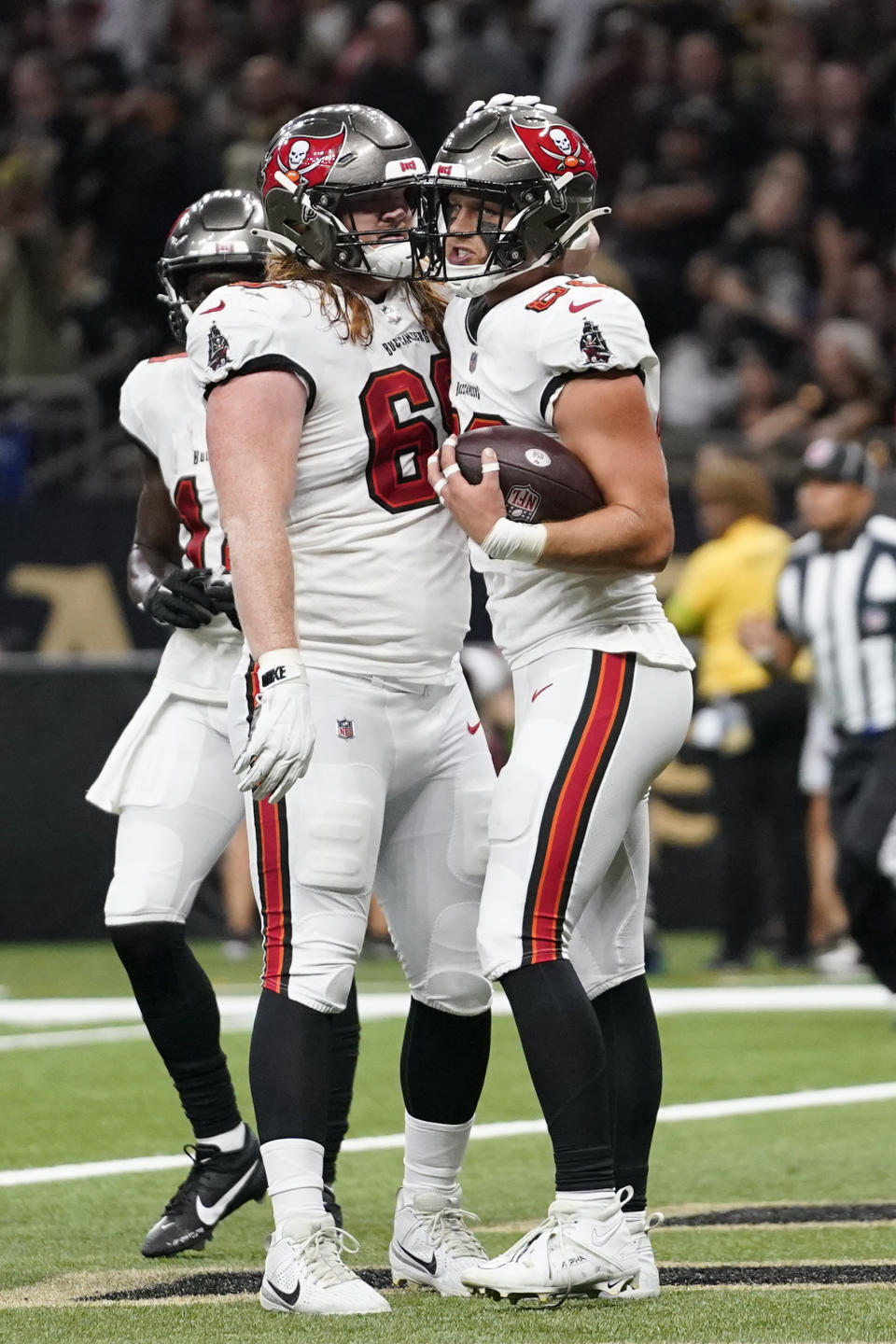 Tampa Bay Buccaneers tight end Cade Otton (88), right, is congratulated by guard Cody Mauch (69), left, after scoring a touchdown in the first half of an NFL football game against the New Orleans Saints, in New Orleans, Sunday, Oct. 1, 2023. (AP Photo/Gerald Herbert)