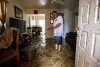 Olban Tremeneo Lagos, 42, points to the water inside his apartment off Southwest Third Street and Eighth Avenue in the Little Havana neighborhood of Miami, on Saturday, June 4, 2022. Parts of South Florida were experiencing road flooding from heavy rain and wind Saturday as a storm system that battered Mexico moved across the state. (Daniel A. Varela/Miami Herald via AP)
