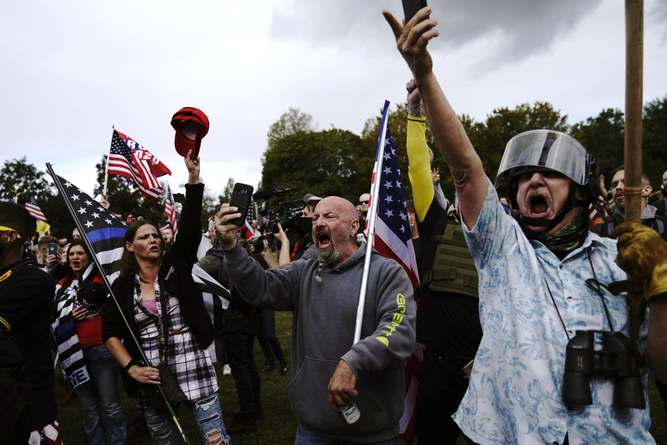 Members of the Proud Boys and other right-wing demonstrators rally on Saturday, Sept. 26, 2020, in Portland, Ore. (AP Photo/John Locher)