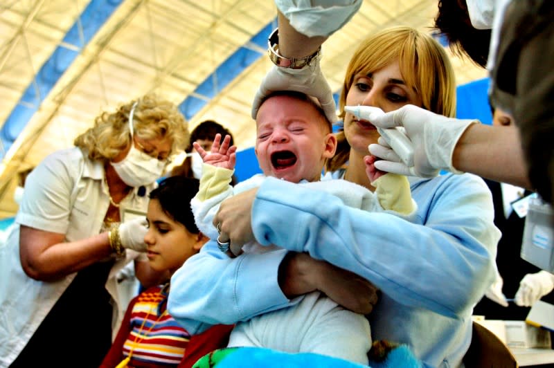 FILE PHOTO: A baby's temperature is checked, as part of SARS screening at Ben Gurion airport