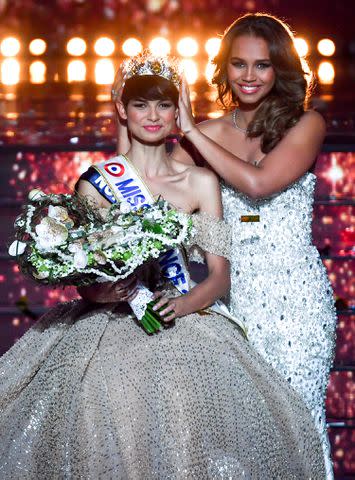 <p>ARNAUD FINISTRE/AFP via Getty Images</p> Eve Gilles is crowned Miss France 2024