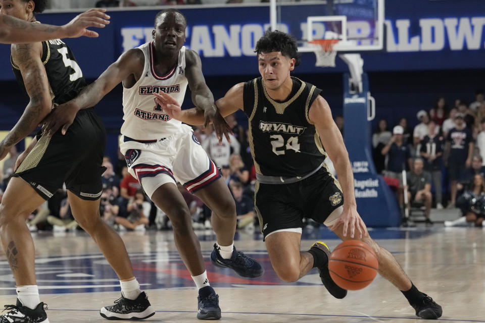 Bryant University guard Rafael Pinzon (24) dribbles around Florida Atlantic guard Johnell Davis (1) during the first half of an NCAA college basketball game, Saturday, Nov. 18, 2023, in Boca Raton, Fla. (AP Photo/Marta Lavandier)