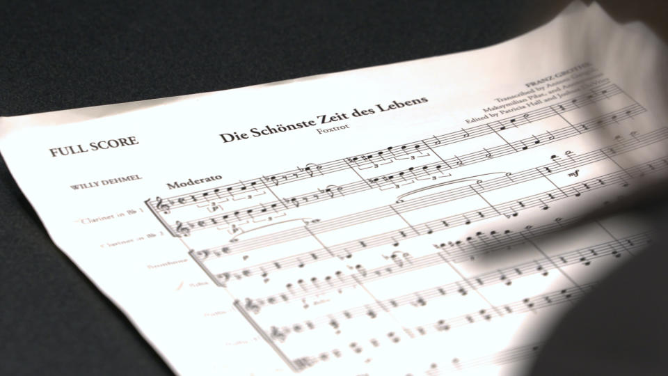 This Nov. 7, 2018, photo provided by the University of Michigan shows the full score for "The Most Beautiful Time of Life (Die Schönste Zeit des Lebens)" at the Duderstadt Center recording studio on campus in Ann Arbor, Mich. The music, recorded by the Contemporary Directions Ensemble under the direction of Professor Oriol Sans, has not been heard since it was arranged and performed by prisoners in a World War II death camp. The ensemble will perform the piece Friday, Nov. 30, 2018, during a free on-campus concert. The handwritten manuscript was discovered by university music theory Professor Patricia Hall while doing research at the Auschwitz-Birkenau Museum in Poland. (Christopher Boyes/University of Michigan via AP)