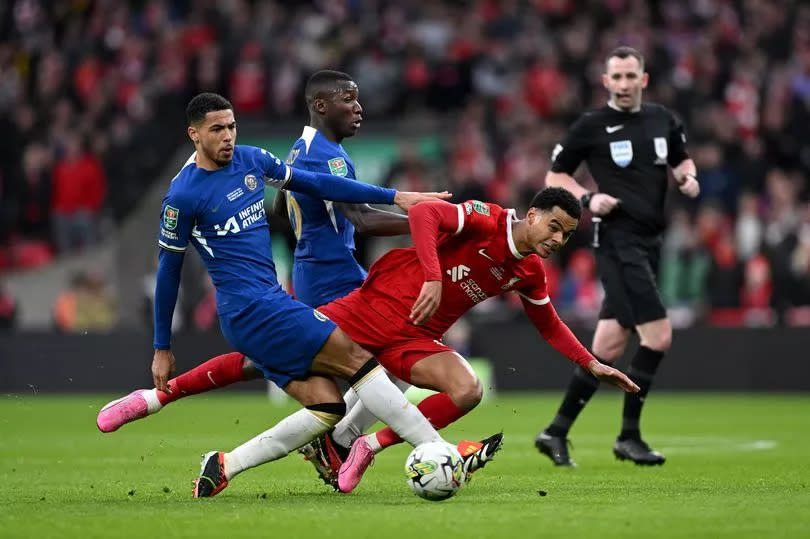 Cody Gakpo of Liverpool is challenged by Levi Colwill and Moises Caicedo of Chelsea during the Carabao Cup Final match between Chelsea and Liverpool at Wembley Stadium on February 25, 2024 in London, England.