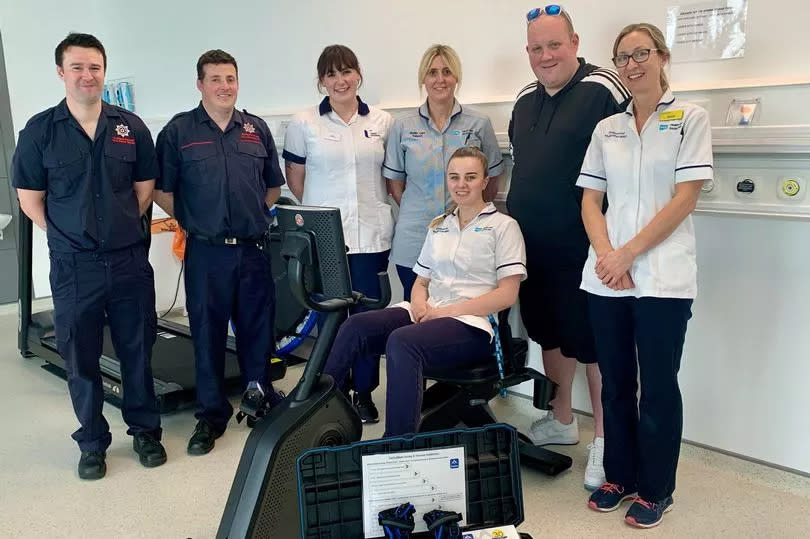 L-R NI Firefighter Mark Adair, NI Fire Service Crew Commander Phil Clint, Physio Student Ciara Orr, Physio Assistant Lynsey Hamilton, Physio Jayne McKeown, Physio Chloe Creighton and Alan’s son, Ben Blair