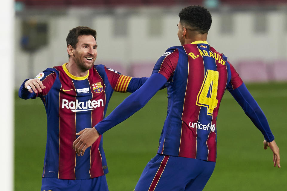 BARCELONA, SPAIN - DECEMBER 19: Ronald Araujo of FC Barcelona celebrates after scoring his team's second goal with his teammate Lionel Messi during the La Liga Santander match between FC Barcelona and Valencia CF at Camp Nou on December 19, 2020 in Barcelona, Spain. Sporting stadiums around Spain remain under strict restrictions due to the Coronavirus Pandemic as Government social distancing laws prohibit fans inside venues resulting in games being played behind closed doors. (Photo by Pedro Salado/Quality Sport Images/Getty Images)