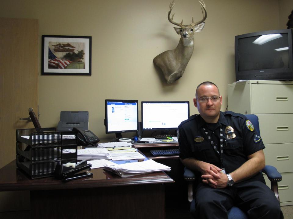 In this Thursday, April 3, 2014 photo, Chattanooga Police Officer Tim McFarland talks about the discovery of a set of 63-year-old twins, who on March 29 were found dead in a home in Chattanooga, Tenn. Each man was found seated in an easy chair inside the modest home they shared for decades, and where they apparently died together about three years ago. (AP Photo/Adrian Sainz)