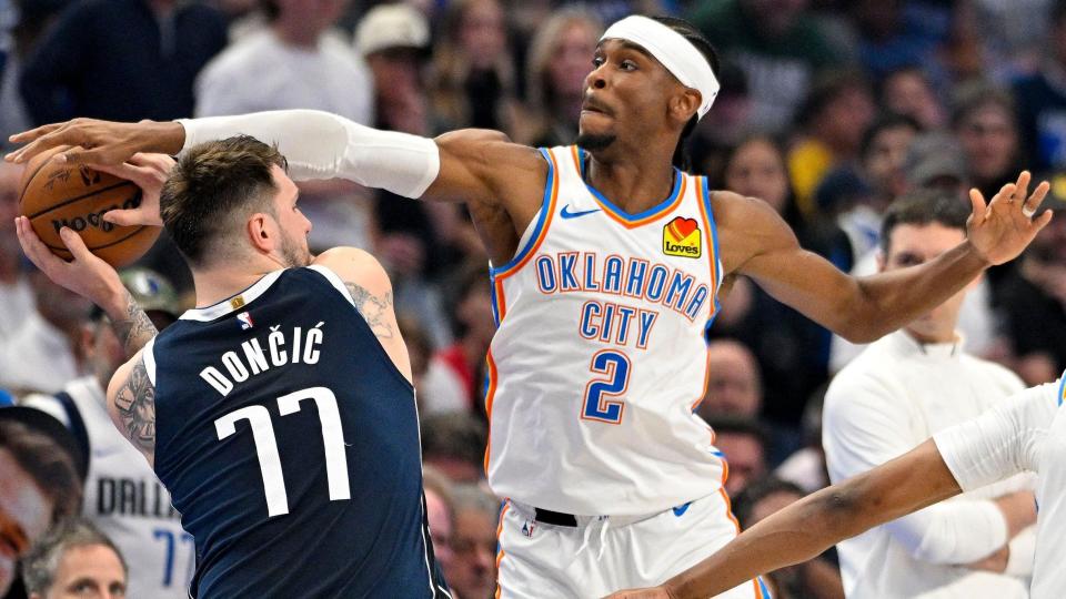 Luka Doncic and Shai Gilgeous-Alexander fight for the ball