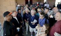 San Francisco Giants former player Barry Bonds, left, speaks after a news conference before a spring training baseball game in Scottsdale, Ariz., Monday, March 10, 2014. Bonds starts a seven day coaching stint today. (AP Photo/Chris Carlson)