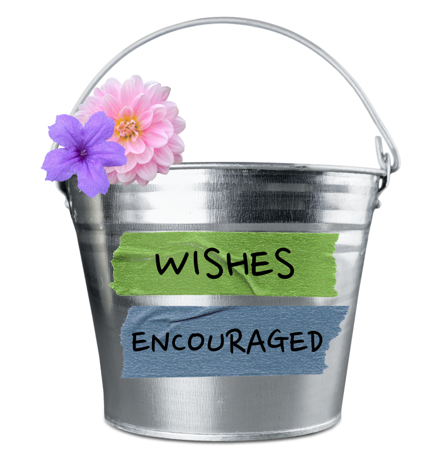 A metal bucket with flowers attached on the side and text saying "Wishes Encouraged."