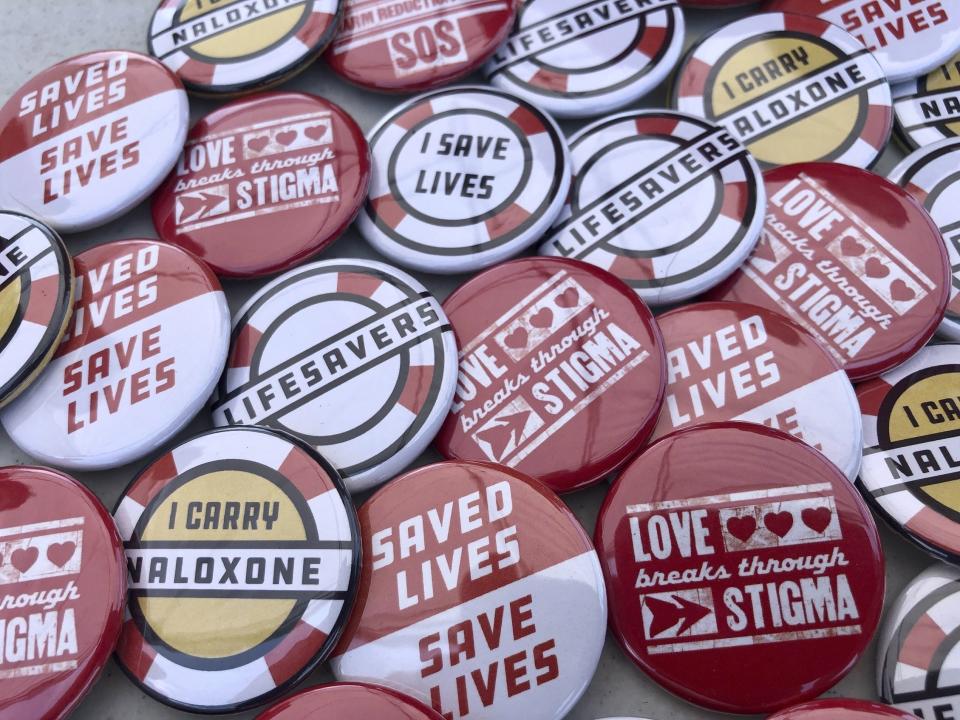 FILE - In this June 26, 2021 file photo, buttons are displayed at a tent during a health event in Charleston, W.Va. Under the recommendations of an investigation led by the Centers for Disease Control and Prevention and released Tuesday, Aug. 3, people who inject drugs in Kanawha County, West Virginia's largest, should have expanded access to sterile syringes, testing and treatment amid one of the nation’s highest spikes of HIV cases. (AP Photo/John Raby, File)