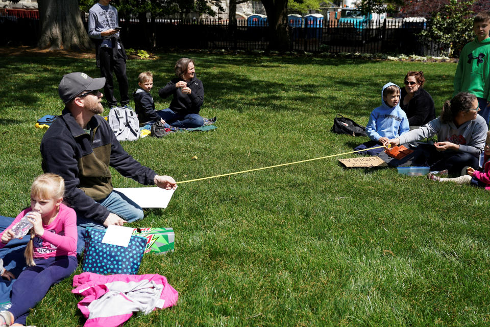 Demonstrators measure out a 'social distance' of six feet as they gather in opposition to Virginia's stay-at-home order and business closures in the wake of the coronavirus disease (COVID-19) outbreak during a protest against the lockdown measures in Richmond, Virginia, U.S., April 16, 2020. REUTERS/Kevin Lamarque     TPX IMAGES OF THE DAY