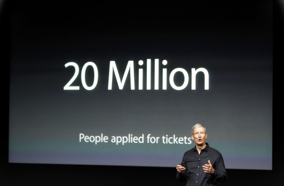 Apple Inc CEO Tim Cook talks about the iTunes Festival with the number of people applying for tickets on the screen during Apple Inc's media event in Cupertino, California September 10, 2013. (REUTERS/Stephen Lam)