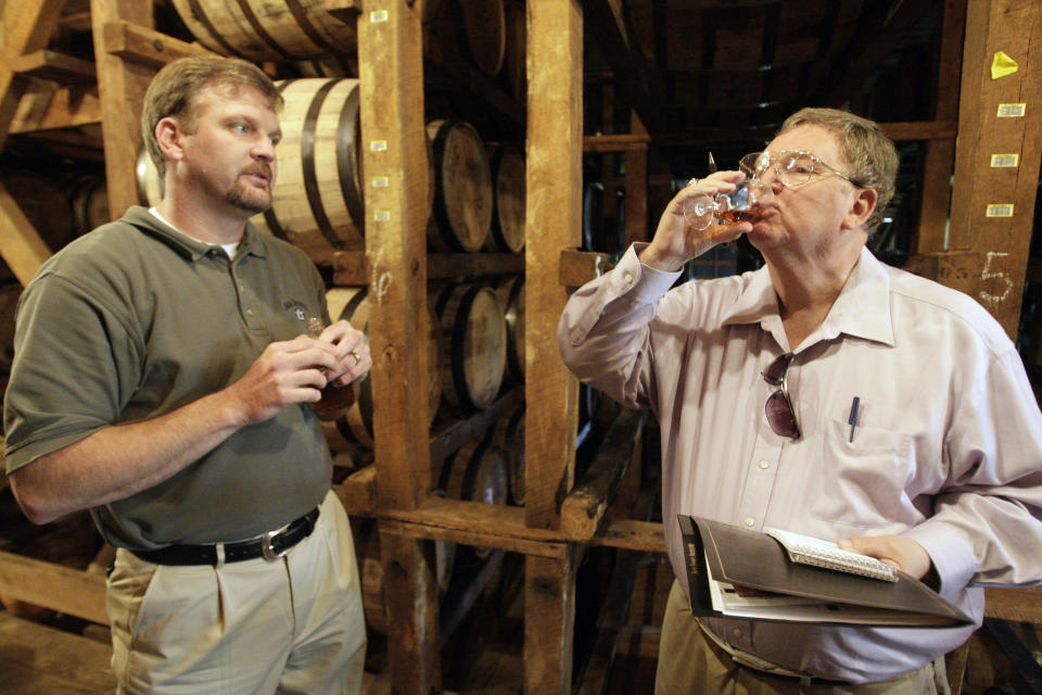 Journalist Joe Edwards, right, samples spirits with Jack Daniel's master distiller Jeff Arnett in Lynchburg, Tenn., Wednesday, May 20, 2009. Edwards, who chronicled Tennessee news for more than 40 years as a newsman for The Associated Press and helped “Rocky Top” become a state song, died Friday, Feb. 3, 2023. He was 75. (AP Photo/Mark Humphrey)