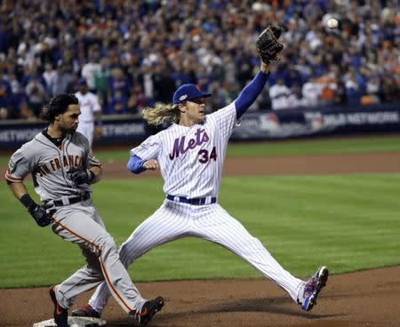 Oct 5, 2016; New York City, NY, USA; San Francisco Giants left fielder Angel Pagan (16) beats New York Mets starting pitcher Noah Syndergaard (34) to first base for an infield single during the seventh inning in the National League wild card playoff baseball game at Citi Field. Mandatory Credit: Anthony Gruppuso-USA TODAY Sports
