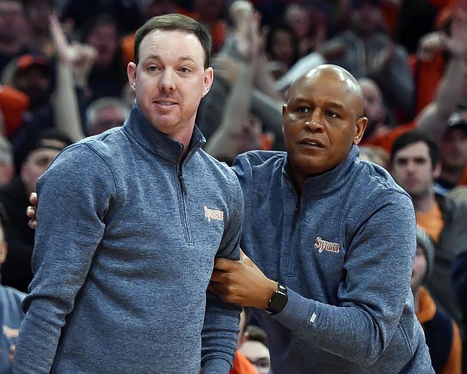 FILE - Syracuse assistant coach Gerry McNamara, left, and associate head coach Adrian Autry, right, react to a call during the second half of an NCAA college basketball game against North Carolina in Syracuse, N.Y., Jan. 24, 2023. Patrolling the sideline this season as coach will be former Syracuse star and longtime assistant Autry, who's challenge is returning the program to what he calls “the Orange Standard.” (AP Photo/Adrian Kraus, File)