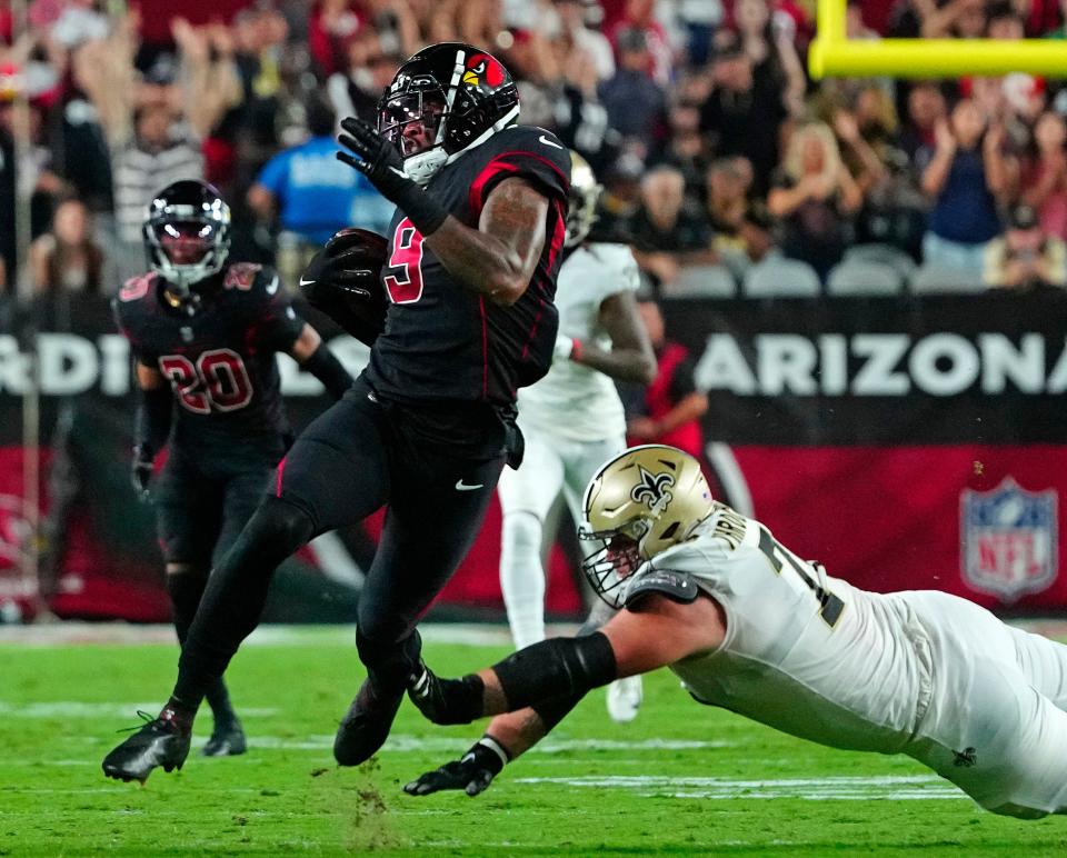 October 20, 2022; Glendale, Ariz; USA; Cardinals Isaiah Simmons (9) returns an interception for a touchdown against the Saints during a game at State Farm Stadium. Mandatory Credit: Patrick Breen-Arizona Republic
