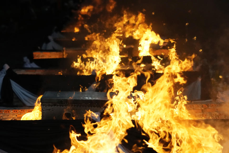 Funeral pyres cremate those who died in the day care center attack at Wat Rat Samakee temple in Uthai Sawan, northeastern Thailand, Tuesday, Oct. 11, 2022. A former police officer burst into a day care center in northeastern Thailand on Thursday, killing dozens of preschoolers and teachers before shooting more people as he fled. (AP Photo/Sakchai Lalit)