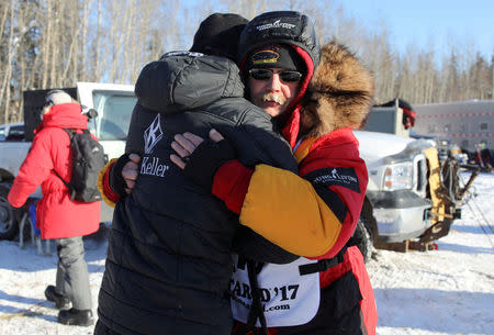 FILE PHOTO: Two-times champion Mitch Seavey hugs son, Dallas Seavey (four-times champion) before they both race at the official restart of the Iditarod, a nearly 1,000 mile (1,610 km) sled dog race across the Alaskan wilderness, in Fairbanks, Alaska, U.S. March 6, 2017. REUTERS/Nathaniel Wilder/File Photo