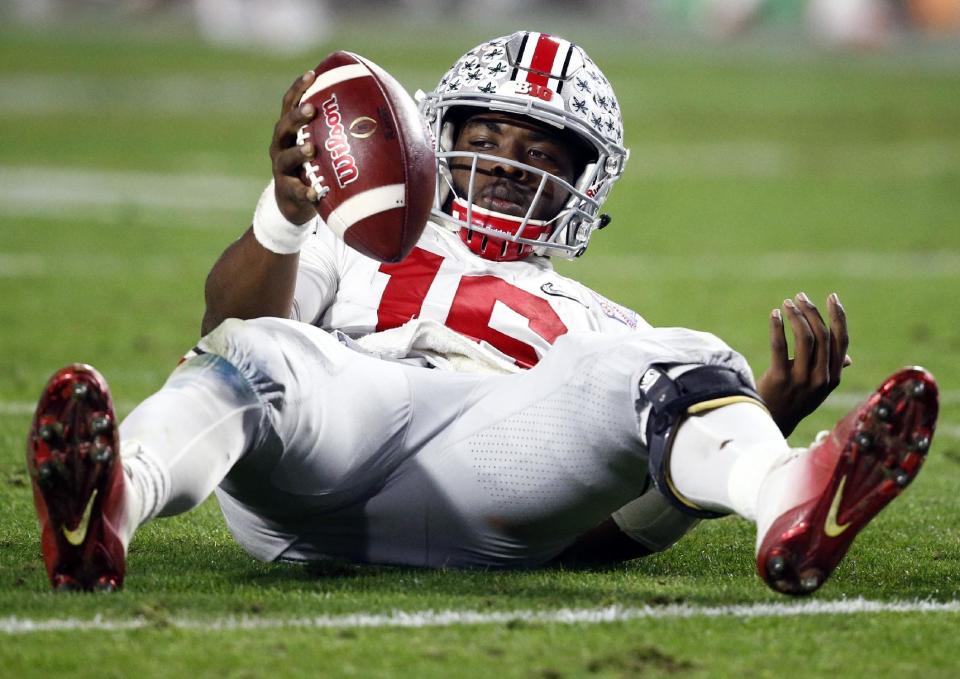 Ohio State quarterback J.T. Barrett looks to the sideline bench after being sacked bu Clemson during the second half of the Fiesta Bowl NCAA college football playoff semifinal, Saturday, Dec. 31, 2016, in Glendale, Ariz. (AP Photo/Ross D. Franklin)