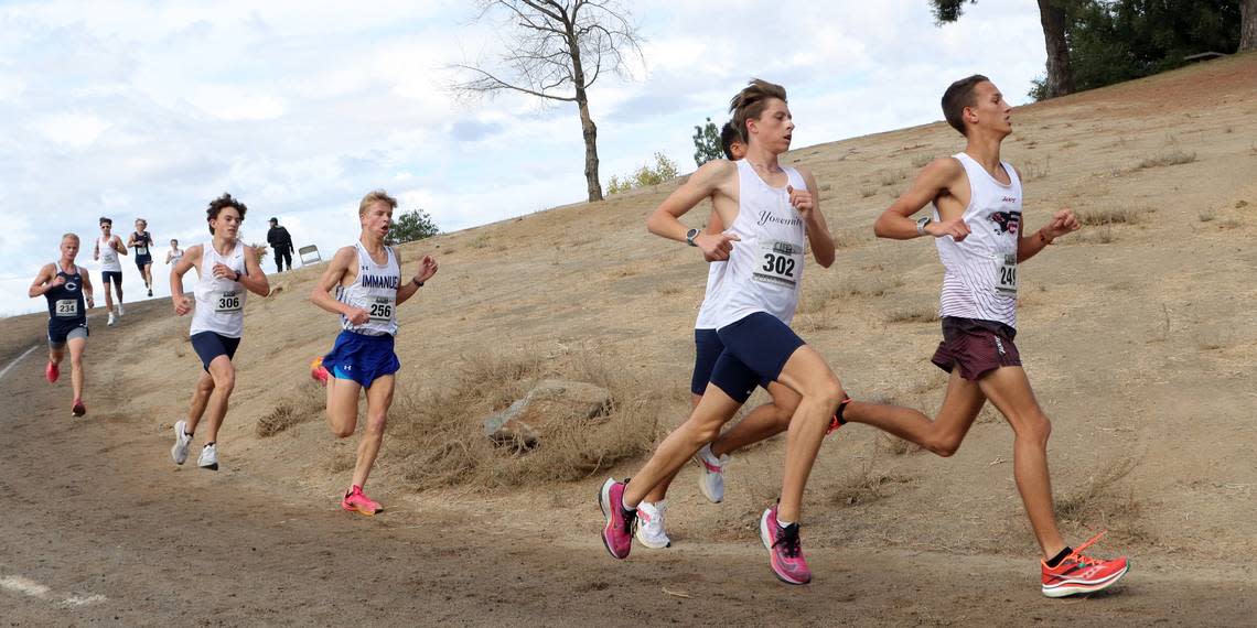 Fresno Christian freshman Blake Bay (1st, 16:11.16) leads Division V runners at the CIF Central Section cross country championships at Woodward Park on Nov. 16, 2023.