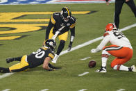 Pittsburgh Steelers quarterback Ben Roethlisberger (7), James Conner (30), and Cleveland Browns defensive end Myles Garrett (95) attempt to recover a fumbled high snap during the first half of an NFL wild-card playoff football game, Sunday, Jan. 10, 2021, in Pittsburgh. Cleveland Browns strong safety Karl Joseph (42) recovered the ball in the end zone for a touchdown. (AP Photo/Keith Srakocic)