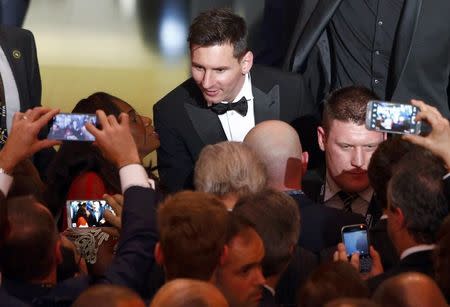 FC Barcelona's Lionel Messi of Argentina talks with guests after receiving the World Player of the Year award during the FIFA Ballon d'Or 2015 ceremony in Zurich, Switzerland, January 11, 2016. REUTERS/Arnd Wiegmann