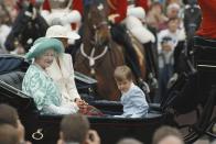 <p>The Queen Mother, Princess Diana, and Prince William riding in a horse-drawn carriage during the parade.</p>