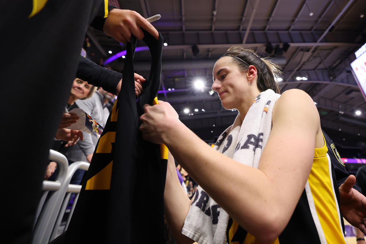 EVANSTON, ILLINOIS - JANUARY 31: Caitlin Clark #22 of the Iowa Hawkeyes signs autographs after the game against the Northwestern Wildcats at Welsh-Ryan Arena on January 31, 2024 in Evanston, Illinois. (Photo by Michael Reaves/Getty Images)