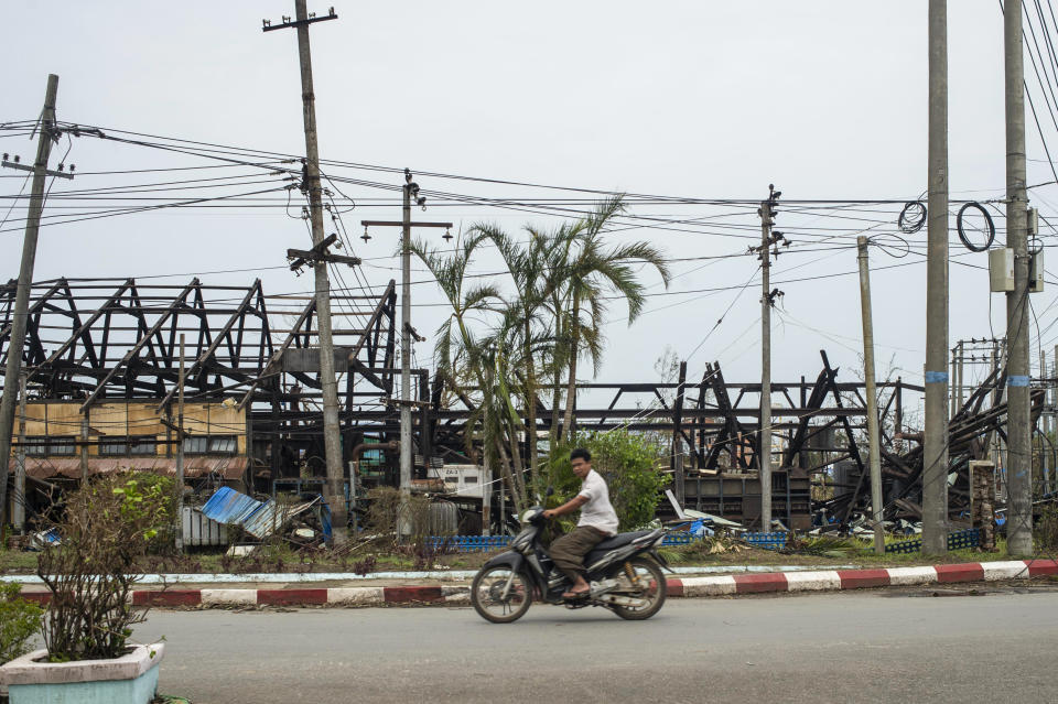 A man rides motorbike past damaged buildings after Cyclone Mocha in Sittwe township, Rakhine State, Myanmar, Tuesday, May 16, 2023. Myanmar’s military information office said the storm had damaged houses and electrical transformers in Sittwe, Kyaukpyu, and Gwa townships. (AP Photo)