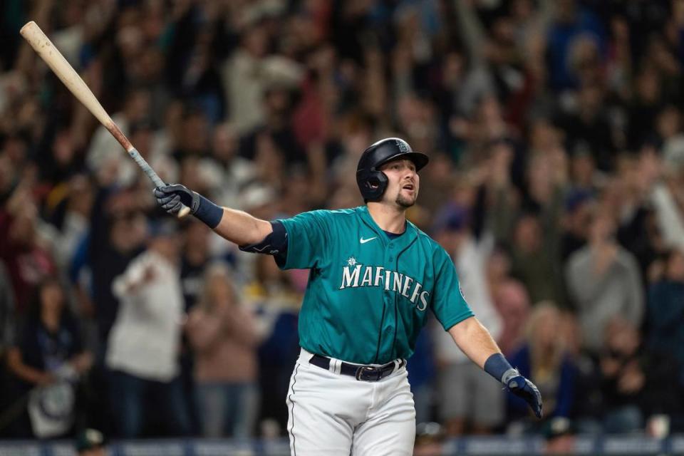 Seattle Mariners’ Cal Raleigh watches his solo home run off Oakland Athletics relief pitcher Domingo Acevedo during the ninth inning of a baseball game Friday, Sept. 30, 2022, in Seattle. The Mariners won 2-1 to clinch a spot in the playoffs. (AP Photo/Stephen Brashear)