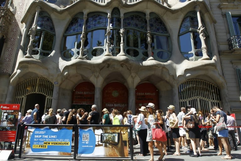 Tourists queue to visit Spanish architect Gaudi's Casa Batllo, in Barcelona