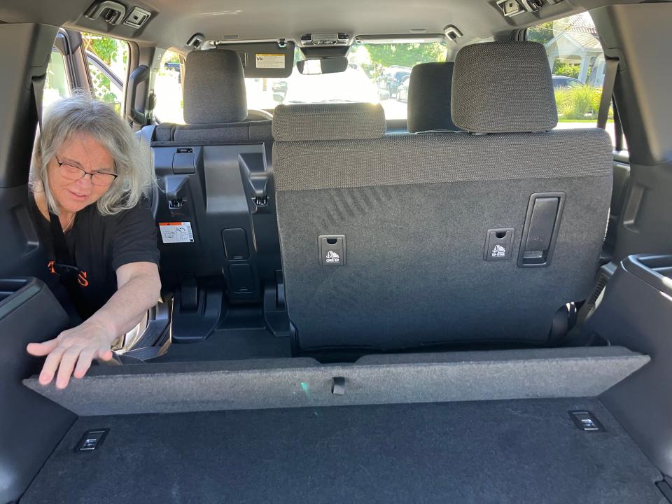 A person adjusts the back area of a Toyota Land Cruiser