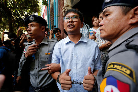 Detained Reuters journalist Wa Lone (C) talks to reporters after his hearing in Yangon, Myanmar April 25, 2018. REUTERS/Stringer