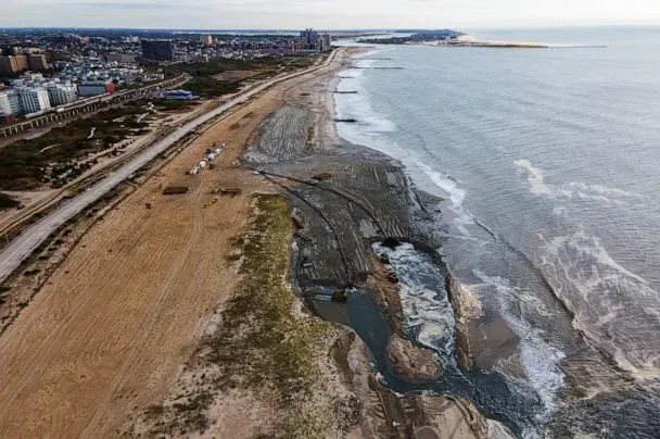 PHOTO: Contractors for the U.S. Army Corps of Engineers pump sand from the ocean floor onto the beach in the Rockaway Peninsula in New York City, Oct. 18, 2022. (Ted Shaffrey/AP, FILE)