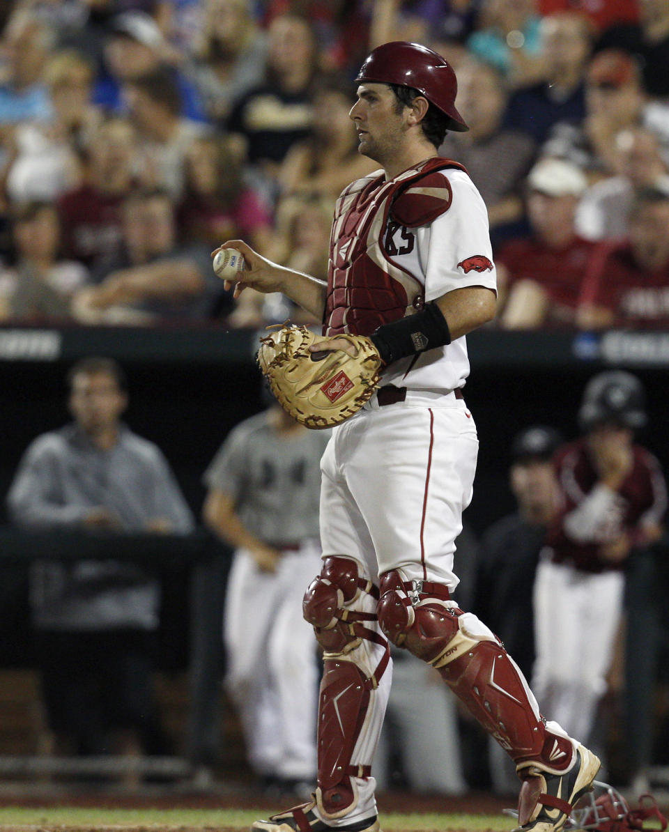 June 21, 2012; Omaha, NE, USA; Arkansas Razorbacks catcher Jake Wise (19) holds the ball after tagging out a runner during the game against the South Carolina Gamecocks during the sixth inning of game twelve of the 2012 College World Series at TD Ameritrade Park. South Carolina won 2-0. Mandatory Credit: Bruce Thorson-USA TODAY Sports