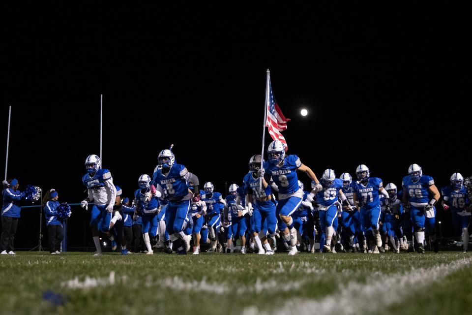 Marian players take the field prior to the Brebeuf Jesuit-Marian Semi-State high school football game on Friday, November 19, 2021, at Bob Otolski Field in Mishawaka, Indiana. High school football in Indiana begins tonight.