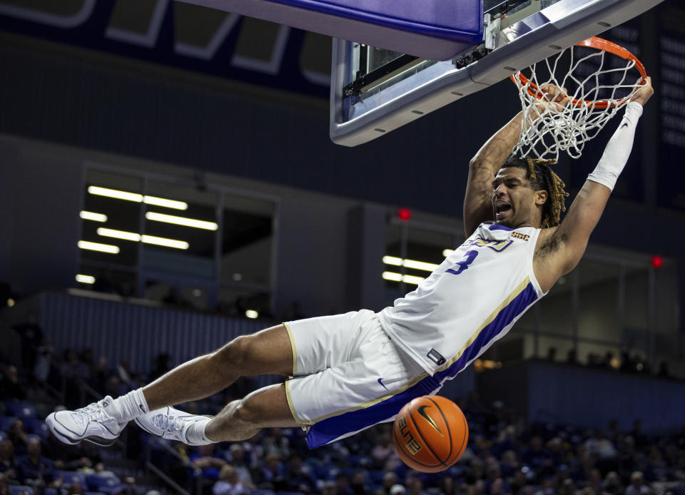 James Madison forward T.J. Bickerstaff (3) slam dunks the ball on a breakaway play during the second half of an NCAA college basketball game against Texas State in Harrisonburg, Va., Saturday, Dec. 30, 2023. (Daniel Lin/Daily News-Record via AP)