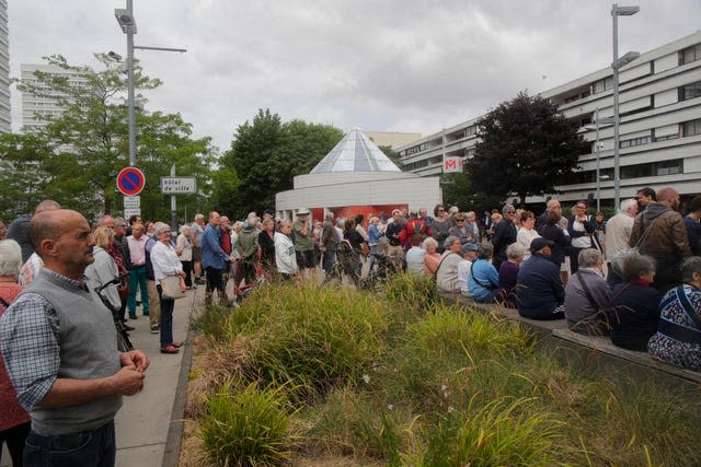 Residents gather in front of the city hall in Mons-en-Baroeul in northern France in a show of solidarity with the mayor of the Paris suburb of L’Hay-les-Roses after a burning car struck his home 