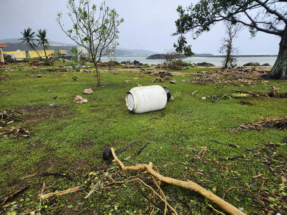 In this photo provided by Chris Leavitt, a 100-gallon propane tank lies in the middle of a field Thursday, May 25, 2023, in Yigo, Guam, after Typhoon Mawar passed over the island. (Chris Leavitt via AP)