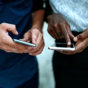 Close-up of couple using smartphone