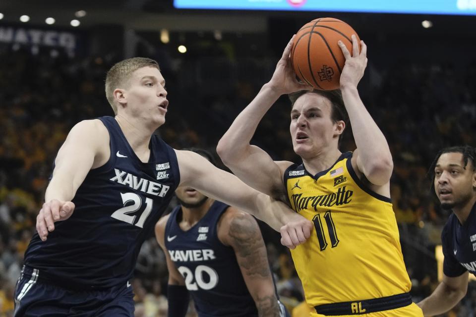 Marquette's Tyler Kolek drives past Xavier's Sasa Ciani during the first half of an NCAA college basketball game Sunday, Feb. 25, 2024, in Milwaukee. (AP Photo/Morry Gash)