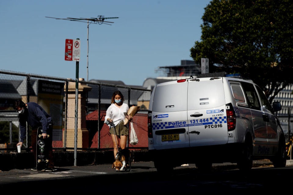 A woman walks alongside Redfern station in Sydney, Australia. 