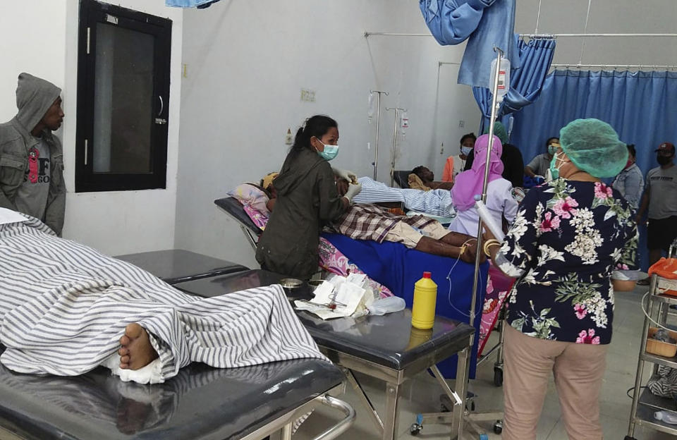 Flood survivors receive medical treatment at a hospital on Lembata Island, East Nusa Tenggara province, Indonesia, Sunday, April 4, 2021 photo. Multiple disasters caused by torrential rains in eastern Indonesia have left dozens of people dead or missing while displacing thousands, the country's disaster relief agency said Monday. (AP Photo/Ricko Wawo)