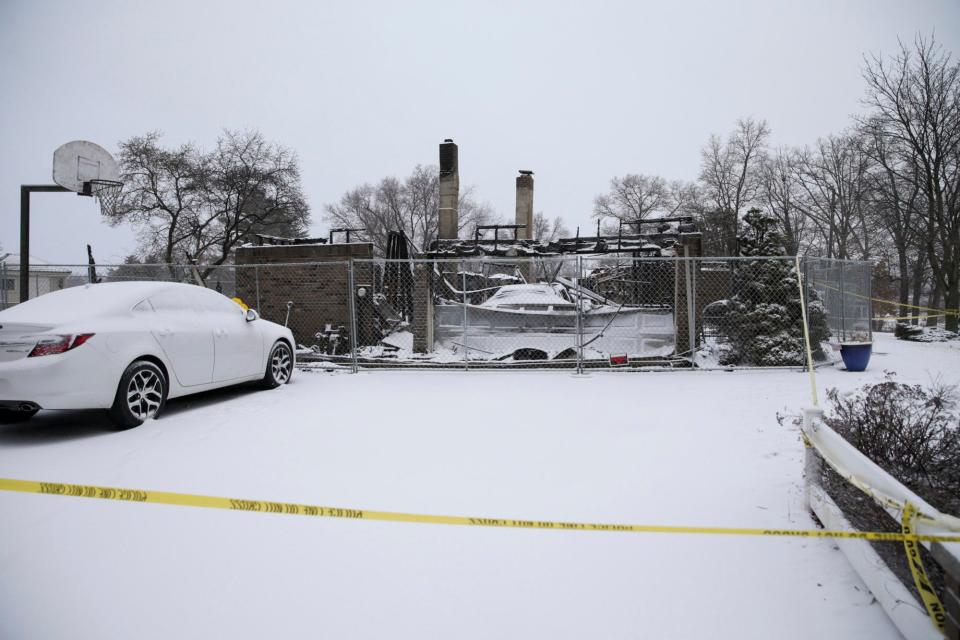 Police tape surrounds a home on North Lakeshore Drive where two people died in an early morning fire, Thursday, Feb. 17, 2022 in Monticello .