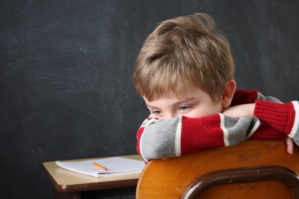 Bored and frustrated boy at school