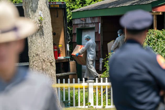 Crime laboratory officers removes boxes as law enforcement searches the home of Rex Heuermann on July 15, 2023, in Massapequa Park, New York. Heuermann, a Long Island architect, was charged Friday with murder in the deaths of three of the 11 victims in a long-unsolved string of killings known as the Gilgo Beach murders.