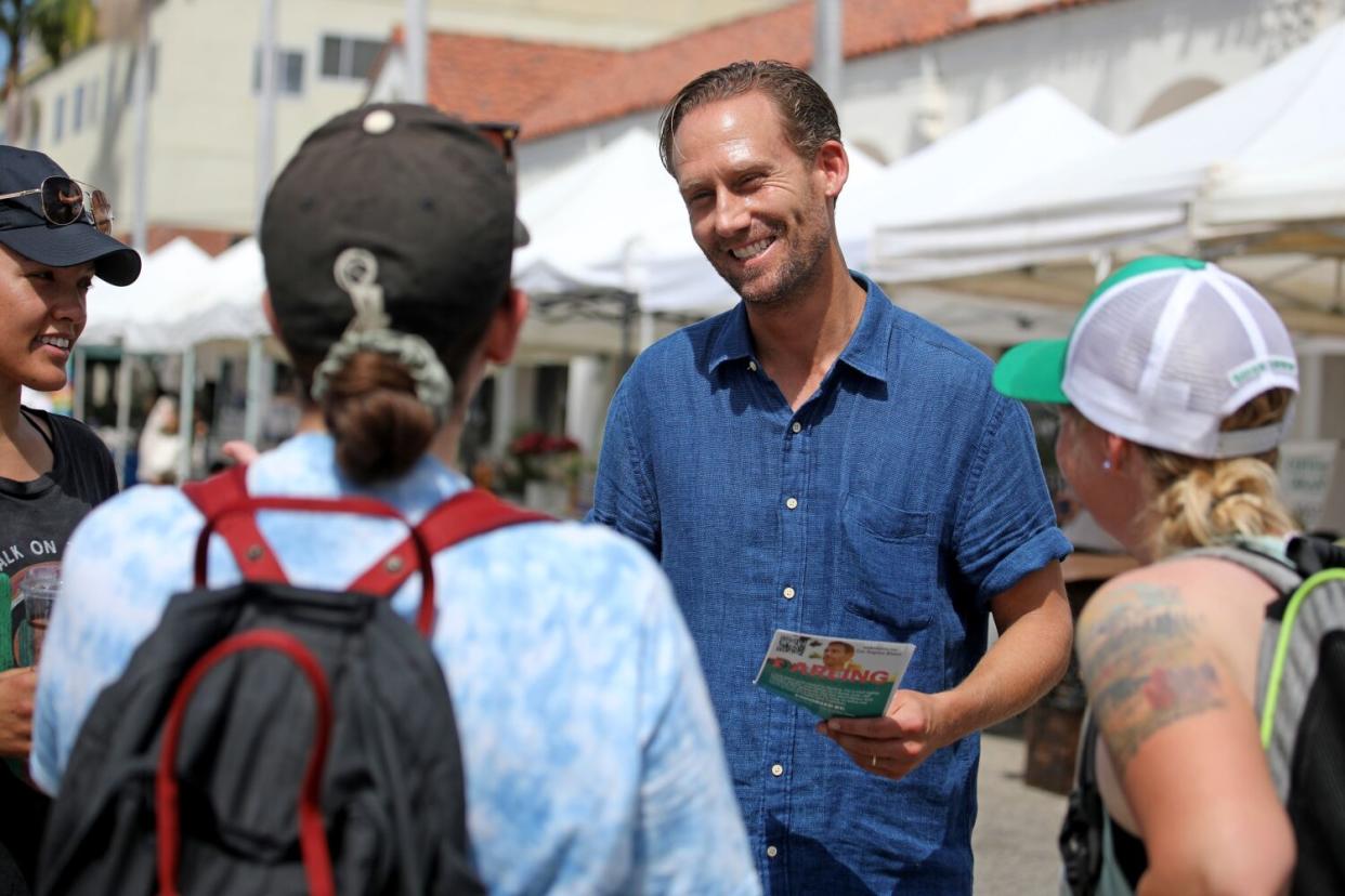 Attorney Erin Darling, a candidate for City Council, greets voters at the Pacific Palisades Farmers Market.