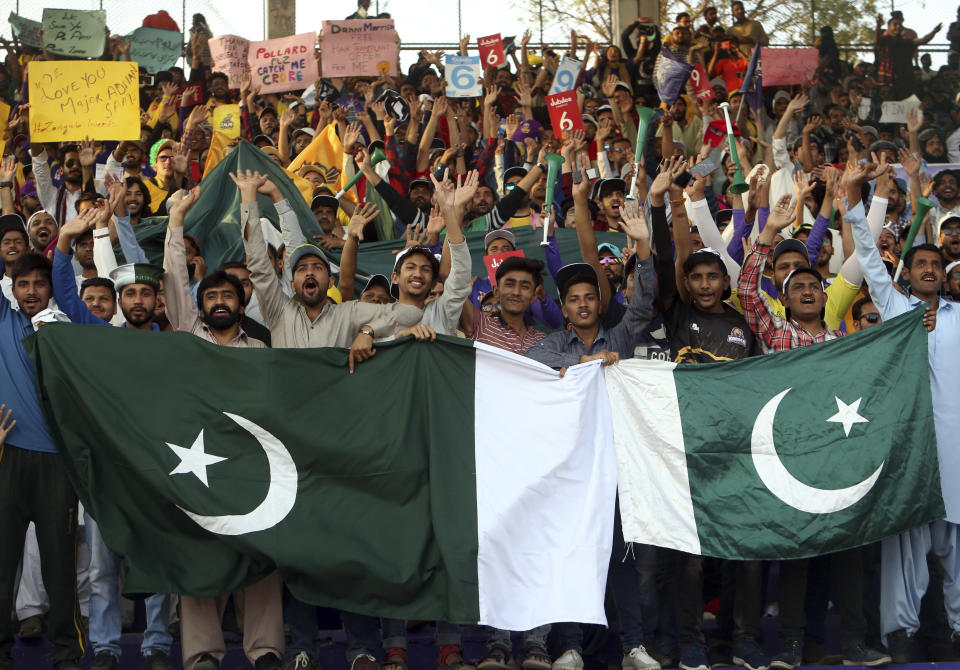 Cricket fans cheer before the start final cricket match of Pakistan Super League at National stadium in Karachi, Pakistan, Sunday, March 17, 2019. (AP Photo/Fareed Khan)